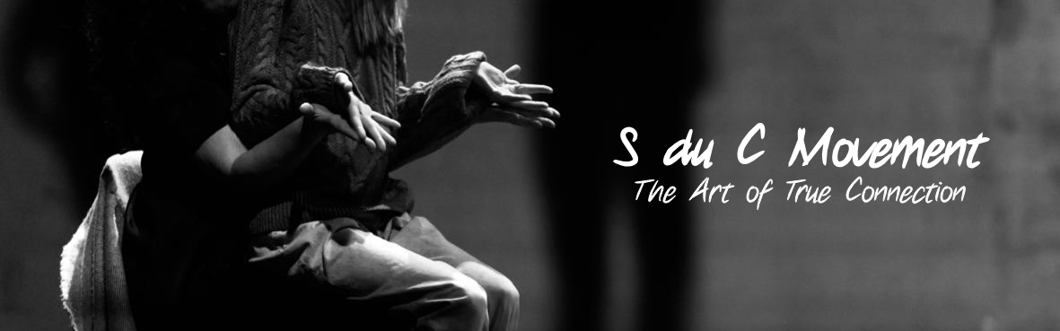 Image of an emotional dance performed in a theater by a dance coach and her student. The Scenario du Coeur title and tagline are overlayed. 