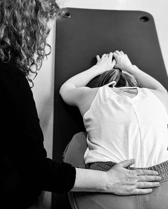 Personal guidance by a dance and theater instructor during a workshop on emotional movement.