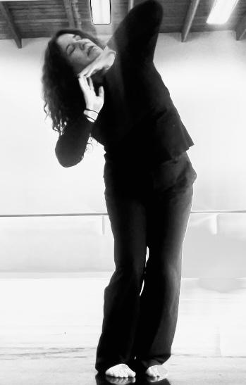 Personal guidance by a dance and theater instructor during a workshop on emotional movement.